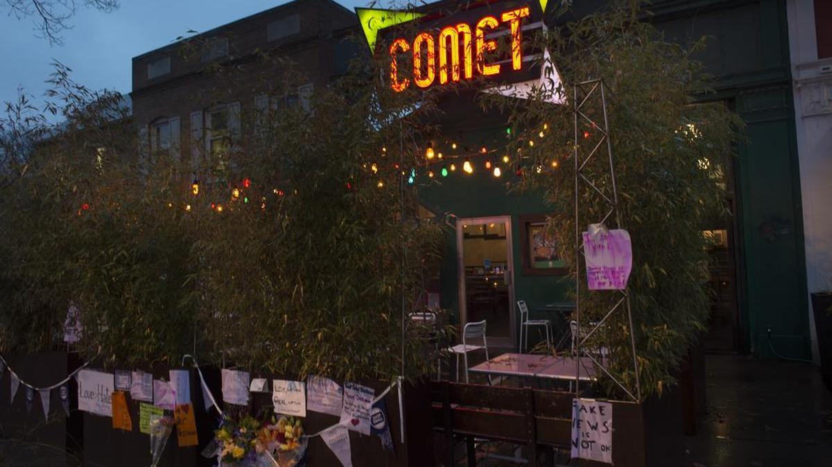 Signs of support hang outside Comet Ping Pong in Washington, D.C., two days after a man from North Carolina, claiming he was investigating a child sex trafficking ring run by Hillary Clinton, fired a weapon inside. The reports of the trafficking ring came from fake news sites.