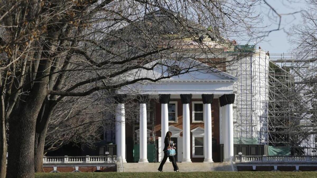 In this Feb. 20, 2013, file photo, a student walks across the Lawn in front of the Rotunda at the University of Virginia in Charlottesville, Va., while the Rotunda was undergoing renovation.
