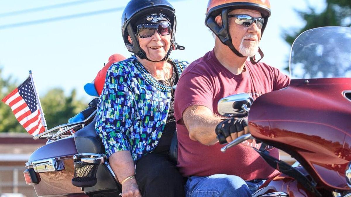 David Owen drives Stella Sarandis down Pio Nono Avenue on her surprise motorcycle ride to celebrate her 90th birthday.