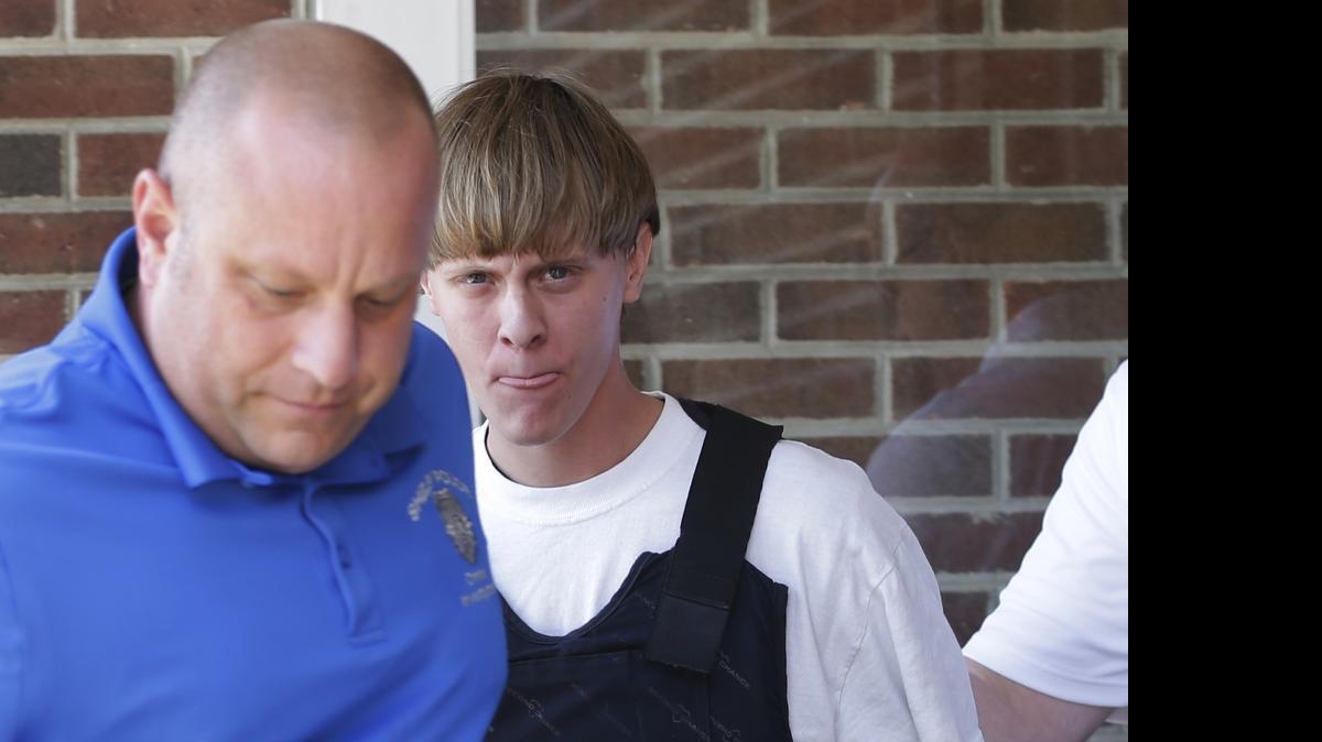 
Charleston, S.C., shooting suspect Dylann Storm Roof, center, is escorted from the Sheby Police Department in Shelby, N.C., Thursday, June 18, 2015. Roof is a suspect in the shooting deaths of nine people at the historic Emanuel African Methodist Episcopal Church in Charleston, S.C., on Wednesday, June 17, 2015.
