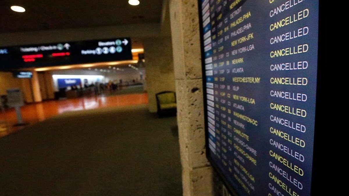 A monitor shows canceled flights in and out of the Palm Beach International airport as Hurricane Matthew advances, Thursday, Oct. 6, 2016, in West Palm Beach, Fla. Officials at Florida’s major airports are monitoring conditions as Hurricane Matthew bears down on Florida.