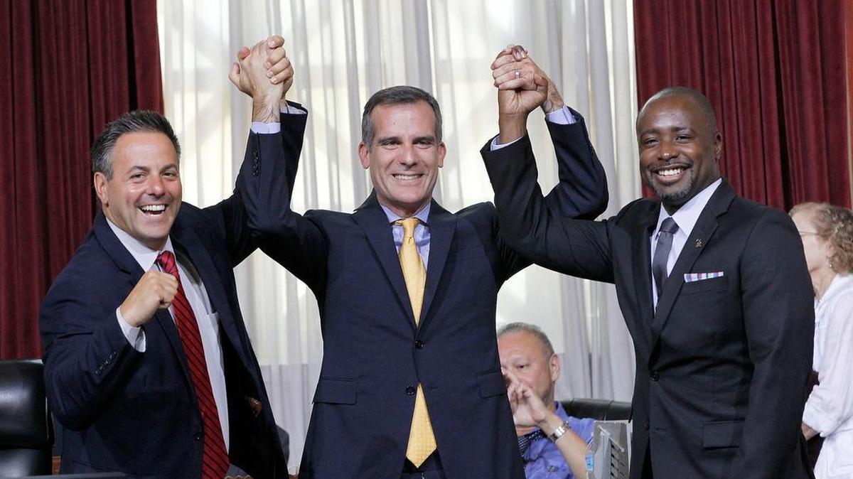 
Councilman Joe Buscaino, left, with Los Angeles Mayor Eric Garcetti, center, and Councilman Marqueece Harris-Dawson celebrate after a city council vote in Los Angeles on Tuesday, Sept. 1, 2015. The Los Angeles City Council cleared the way Tuesday for Garcetti to strike agreements for a 2024 Olympics bid, putting the city on the verge of becoming the U.S. contender after Boston's awkward collapse. 
