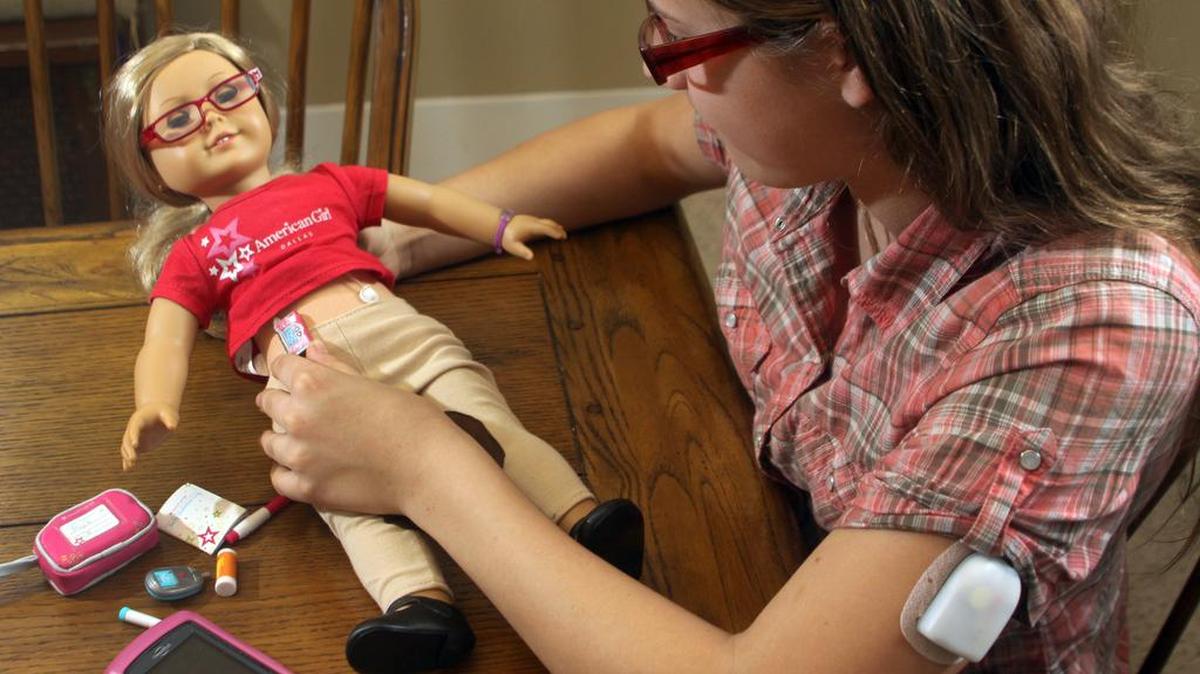 Anja Busse, 13, plays with her American Girl doll, Alice, and her diabetes care kit at her home in Antigo, Wis. Anja, who has Type 1 diabetes, started an online petition urging American Girl to make diabetes accessories for the dolls, rallying the Type 1 diabetes community and garnering 7,000 signatures.