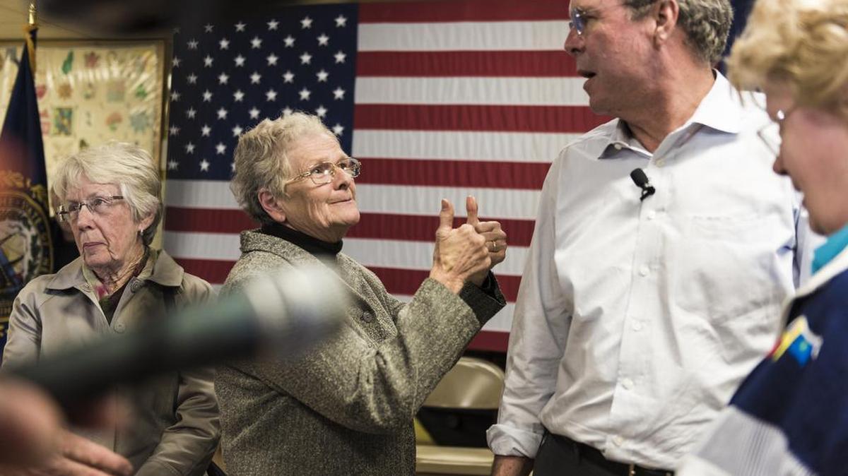 State Representative Kathy Hoelzel gives Jeb Bush two thumbs up after he spoke at a senior center in Raymond, N.H. Bush, Chris Christie and John Kasich are all staking their presidential candidacies on personal campaigning in New Hampshire — an idea that seems increasingly quaint in the social media age.