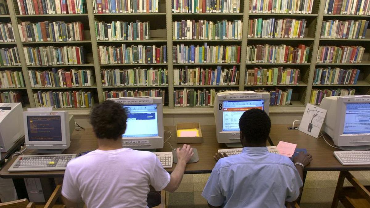 Internet users work at the computers at the Philadelphia Public Library in Philadelphia in this file photo. In Los Angeles, city council members debating the installation of porn-blocking software on computers in all of its libraries.