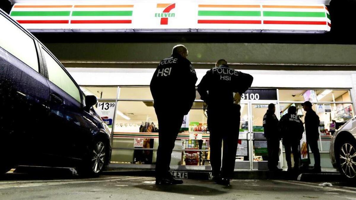 U.S. Immigration and Customs Enforcement agents serve an employment audit notice at a 7-Eleven convenience store Wednesday, Jan. 10, 2018, in Los Angeles. Agents said they targeted about 100 7-Eleven stores nationwide Wednesday to open employment audits and interview workers.