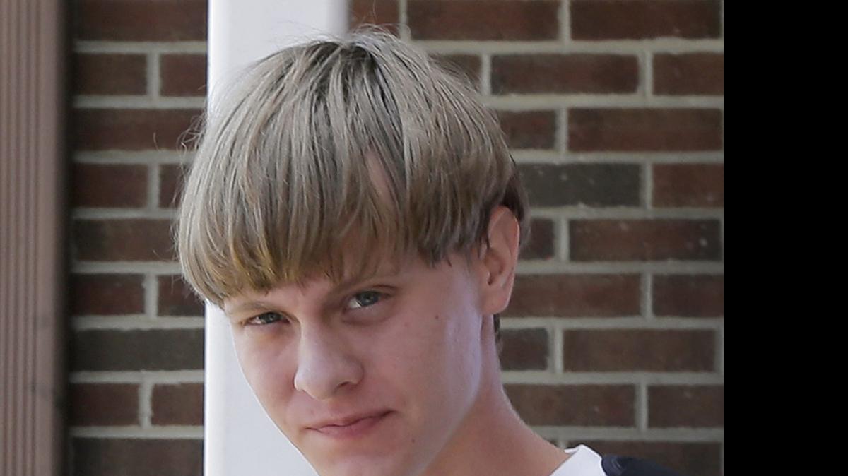 
Charleston, S.C., shooting suspect Dylann Storm Roof is escorted from the Sheby Police Department in Shelby, N.C., on June 18.
