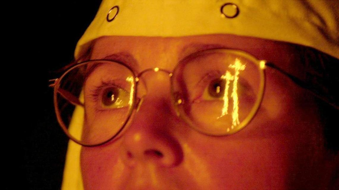 Roxanne of Florida attends a cross lighting ceremony in Pearl, Mississippi on Aug. 26, 2001. The KKK has maintained a high profile this election year.