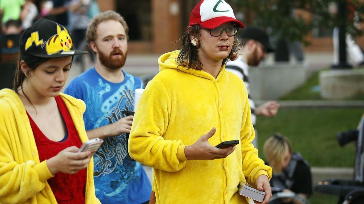 From left, Mandi Keyx, Anthony Pierson and Nate Sexton play "Pokemon Go, "in Springfield, Mo. on Friday, July 15, 2016.