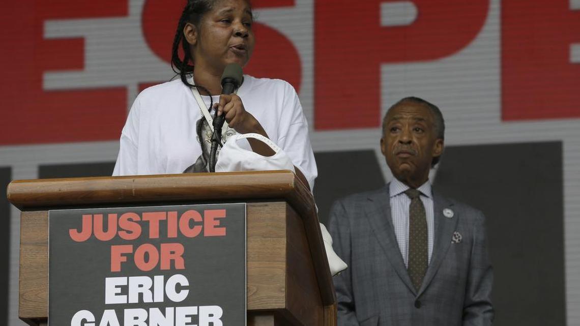 
Eric Garner’s wife, Esaw Snipes, is joined by the Rev. Al Sharpton as she speaks on stage during a rally in New York on Saturday, July 18, 2015. Several hundred people rallied outside the federal courthouse in Brooklyn to demand action in the fatal chokehold death of Garner by a white police officer. 
