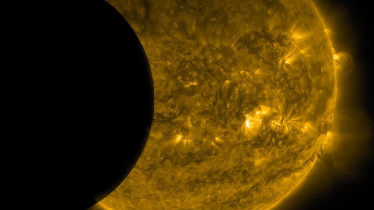 
This Sept. 13, 2015, image provided by NASA shows the moon, left, and the Earth, top, transiting the sun together, seen from the Solar Dynamics Observatory. The edge of Earth appears fuzzy because the atmosphere blocks different amounts of light at different altitudes. This image was taken in extreme ultraviolet wavelengths, invisible to human eyes, but here colorized in gold. A total lunar eclipse will share the stage with a so-called supermoon Sunday evening, Sept. 27, 2015, as seen from the United States. That combination hasn’t been seen since 1982 and won’t happen again until 2033.
