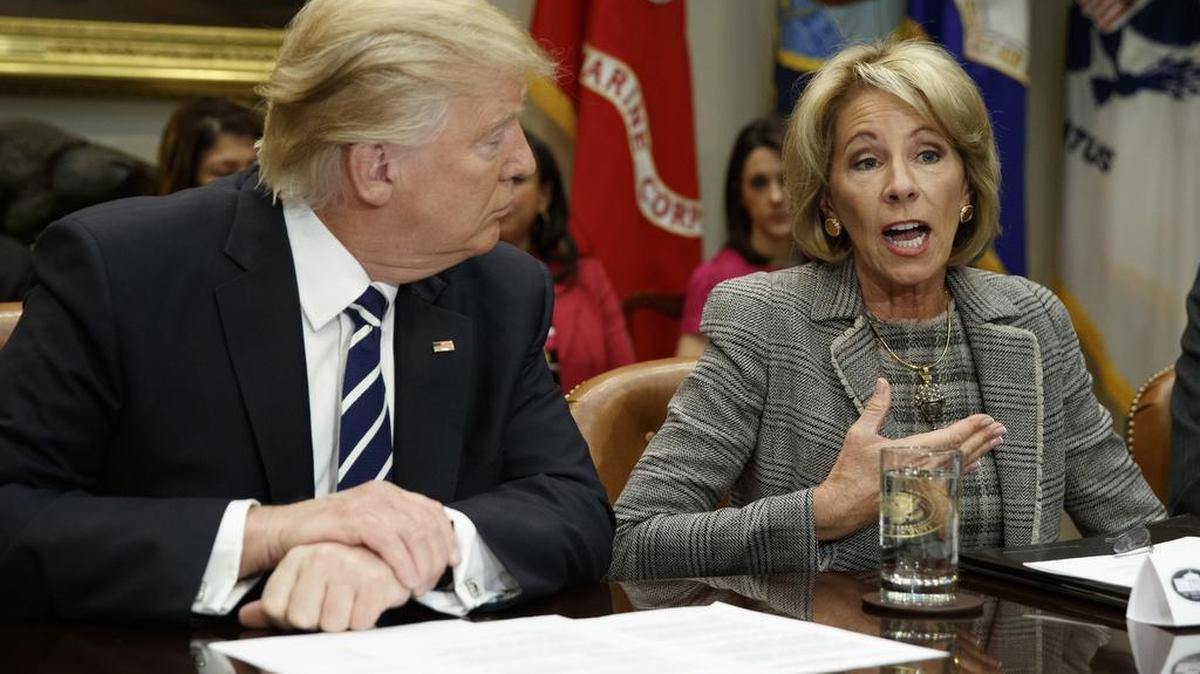 President Donald Trump listens as Education Secretary Betsy DeVos speaks during a meeting with parents and teachers, Tuesday, Feb. 14, 2017, in the Roosevelt Room of the White House in Washington.