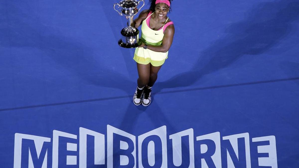 Serena Williams holds the trophy after defeating Maria Sharapova in the women’s singles final at the Australian Open tennis championship in Melbourne, Australia, in January 2015. For the fourth time, Williams has been named The Associated Press Female Athlete of the Year, tying with four-time honoree Chris Evert.