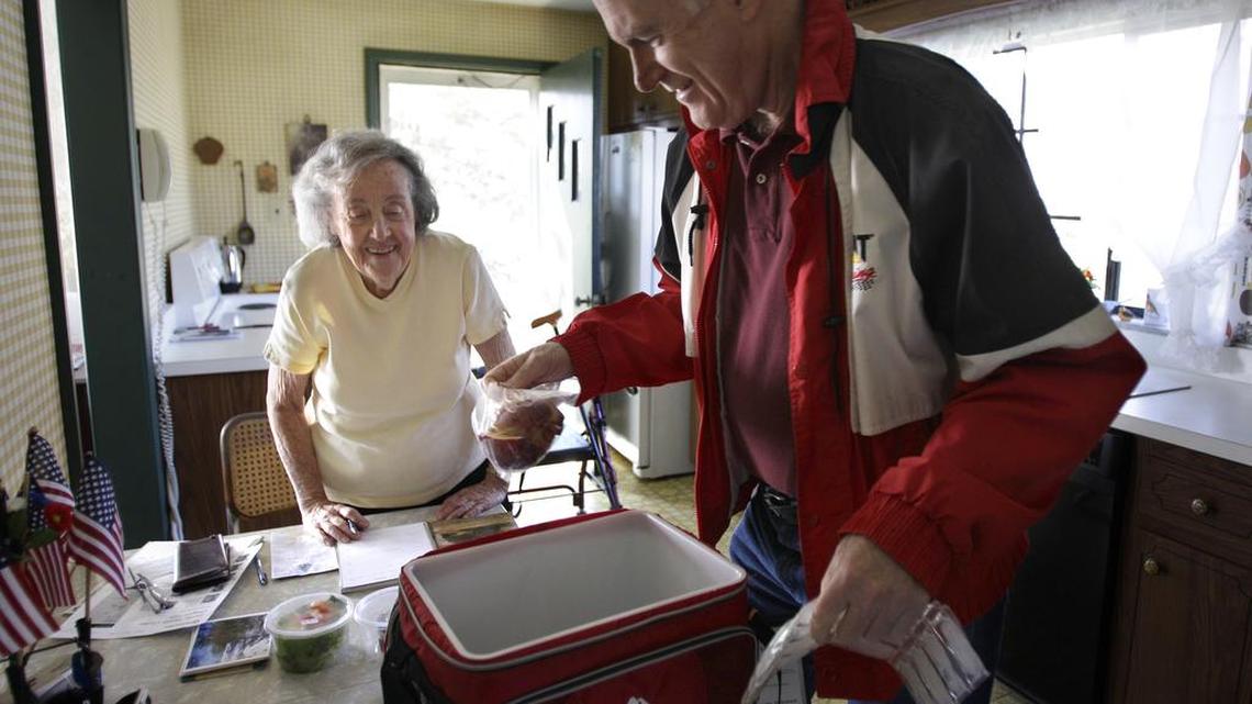 Marty Robertson unpacks food from the Chagrin Falls Meals on Wheels program for recipient Bernadette Winko, 90, in her Bentleyville, Ohio home on Wednesday, March 14, 2012.