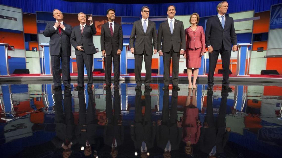 
Republican presidential candidates from left, Jim Gilmore, Lindsey Graham, Bobby Jindal, Rick Perry, Rick Santorum, Carly Fiorina, and George Pataki take the stage for a pre-debate forum at the Quicken Loans Arena, Thursday, Aug. 6, 2015, in Cleveland. 
