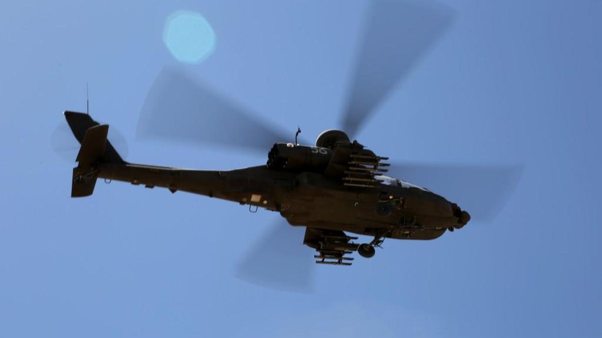 A U.S. Army AH-64 Apache helicopter hovered over the National Training Center during an April 2014 exercise.