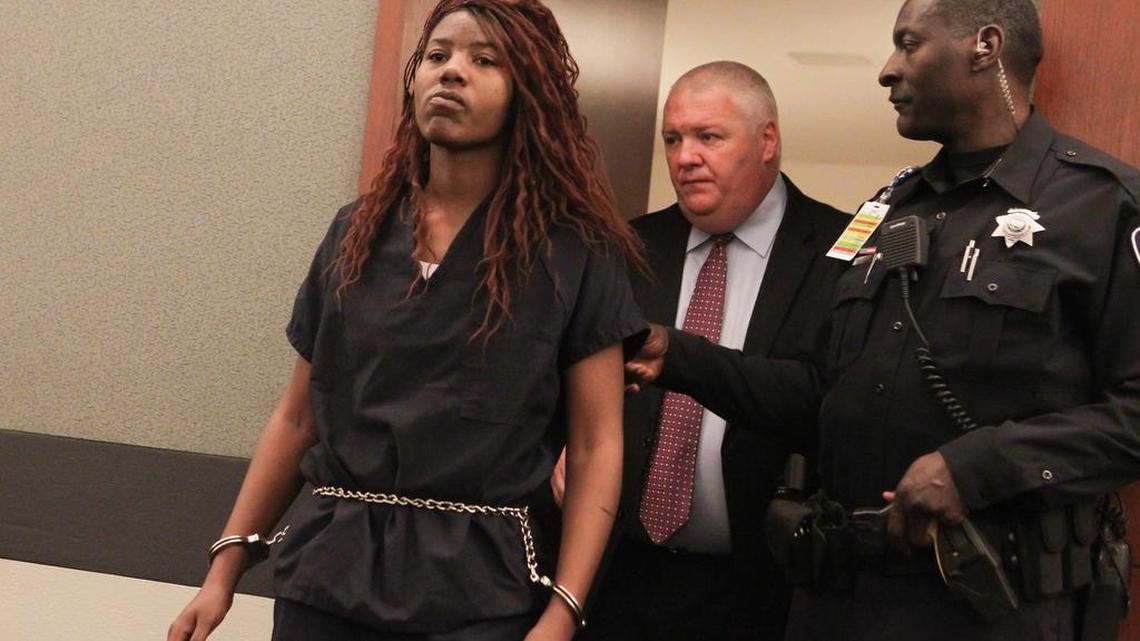 Lakeisha Nicole Holloway enters district court with one of her public defenders, Scott Coffee, for her arraignment Dec. 23 in Las Vegas. Holloway, who crashed her car into pedestrians on the Las Vegas Strip on Dec. 20, now faces a total of 71 felony charges.