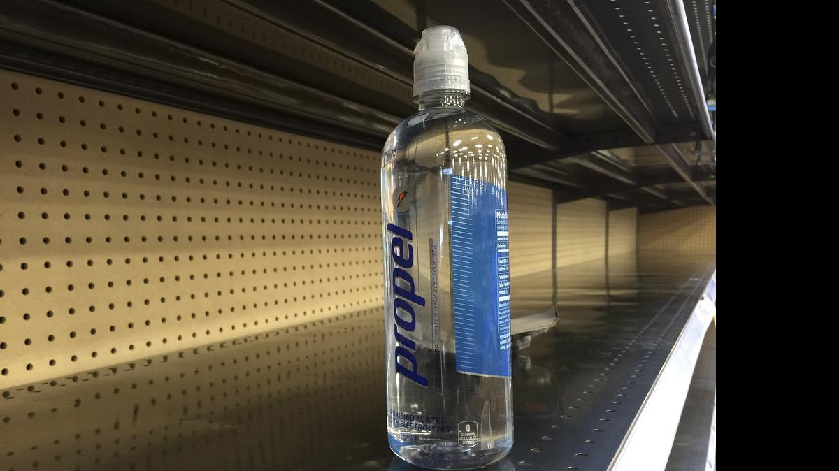 
A bottle of water sits on a nearly empty shelf at a grocery store as residents around Houston quickly snatched up bottled water and other supplies Monday. 
