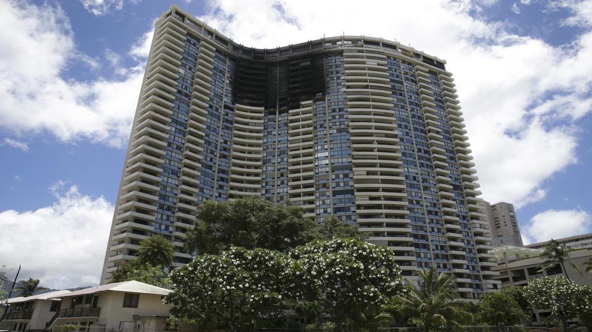 This photo shows the Marco Polo building after a fire gutted several of the top floors of the residential complex, Saturday, July 15, 2017, in Honolulu. A fire broke out Friday afternoon in a unit on the 26th floor, where all three of the dead were found, Fire Chief Manuel Neves said.