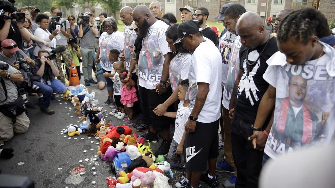 
Michael Brown Sr., his family and friends stop to pray at a memorial to Brown’s son before taking part in a parade in his son’s honor on Saturday, Aug. 8, 2015, in Ferguson, Mo. Sunday will mark one year since Michael Brown Jr. was shot and killed by Ferguson police officer Darren Wilson. 
