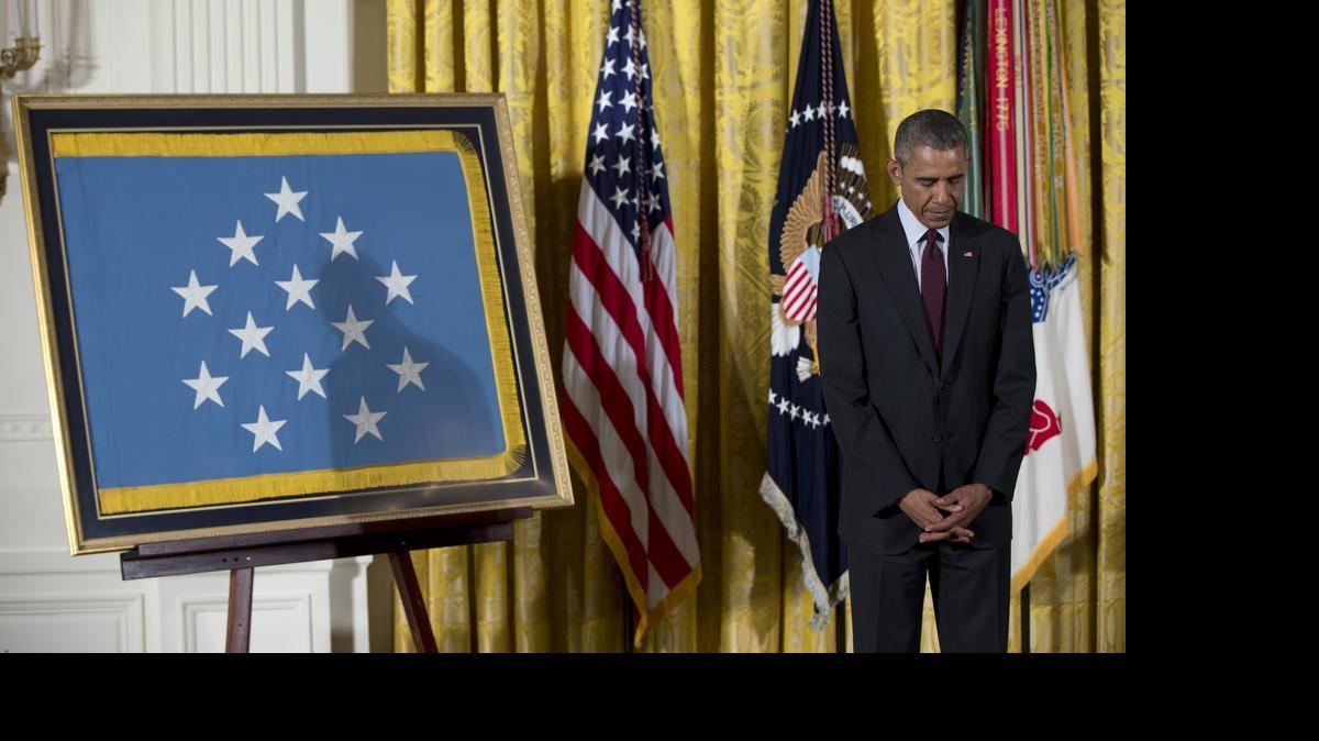 
President Barack Obama bows his head during the benediction in the East Room of the White House in Washington, Tuesday, June 2, 2015, after posthumously bestowing the Medal Of Honor on Army Sgt. William Shemin and Army Pvt. Henry Johnson. Two World War I Army heroes, one black, one Jewish, are finally getting the Medal of Honor they may have been denied because of discrimination, nearly 100 years after bravely rescuing comrades on the battlefields of France.

