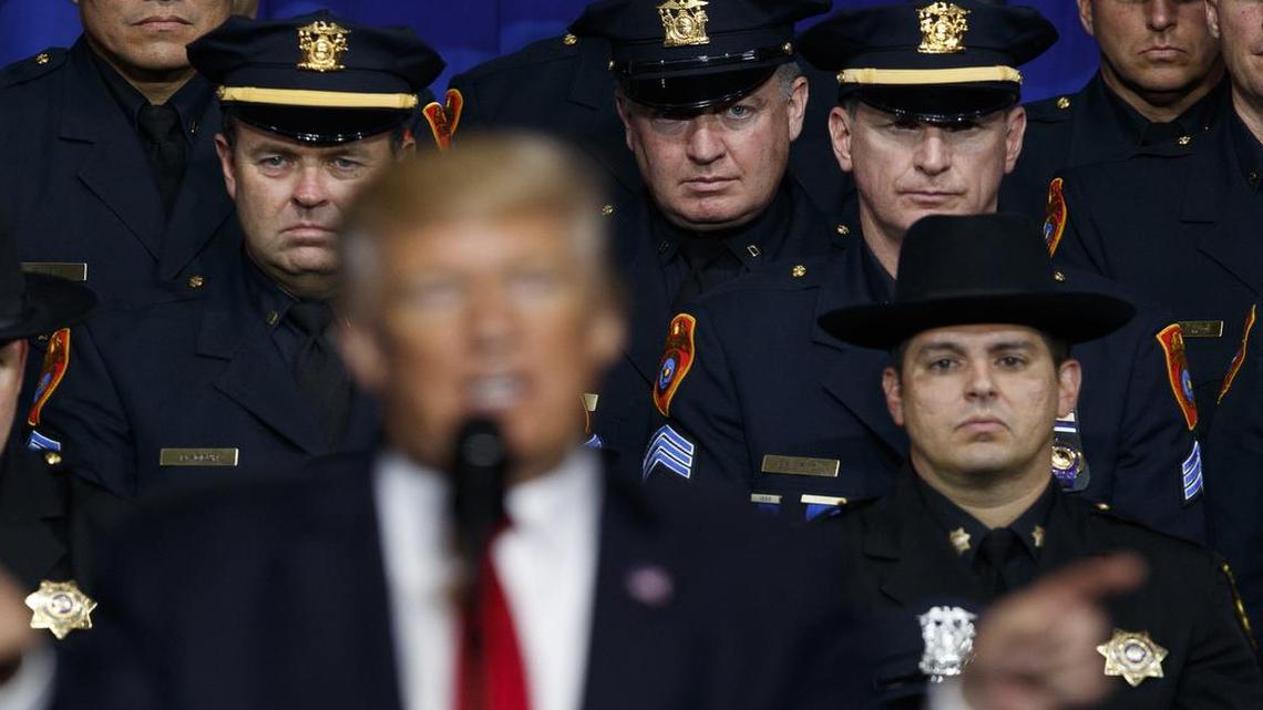Law enforcement officers listen to President Donald Trump speaks about the street gang MS-13, Friday, July 28, 2017, in Brentwood, N.Y.