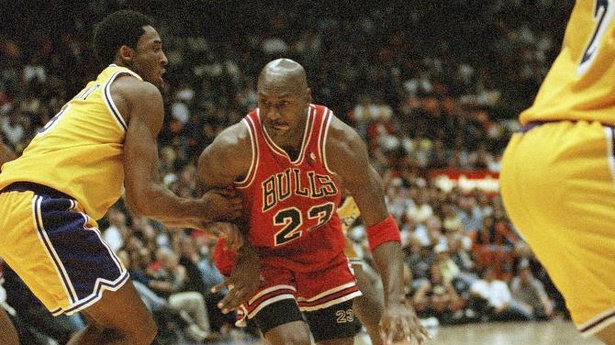 Michael Jordan, right, is defended by the Los Angeles Lakers’ Kobe Bryant during a 1998 game. A pair of Jordan’s Nike sneakers from his fifth game with the Bulls was sold at auction for nearly $1.5 million Sunday, a record.