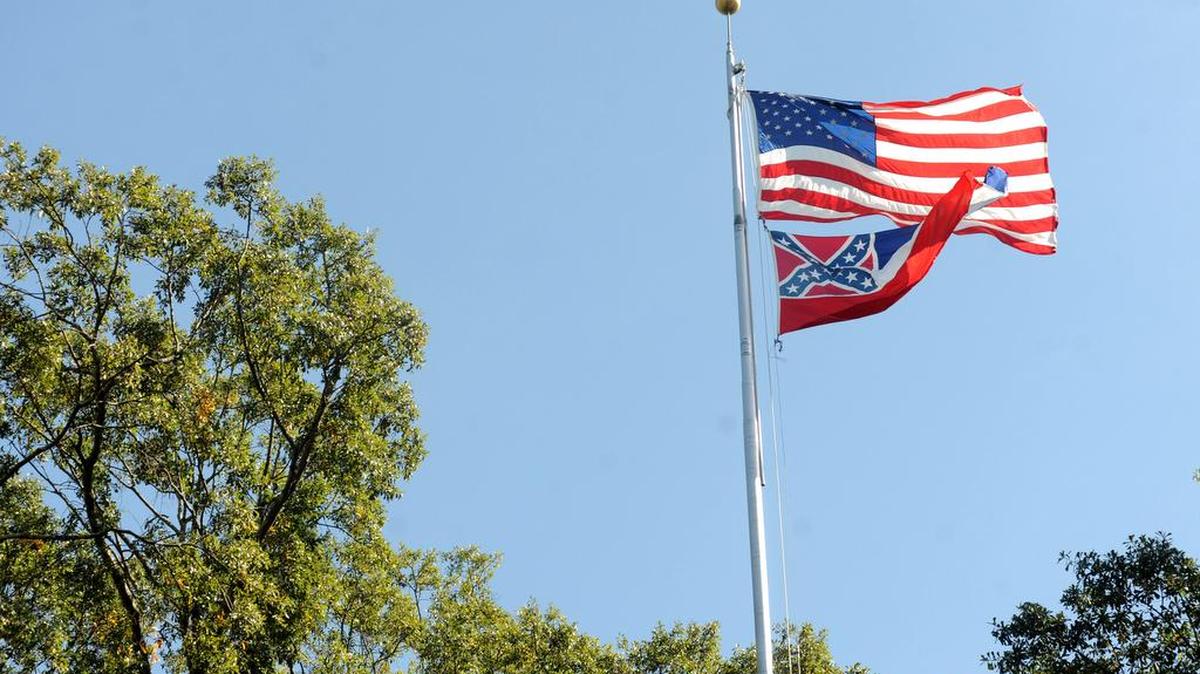 The Mississippi state flag and U.S. flag fly on campus at the University of Mississippi in Oxford, Miss., on Friday, Oct. 16, 2015. The state flag was removed Monday, Oct. 26, 2015, days after the student senate, the faculty senate and other groups adopted a student-led resolution calling for removal of the banner from campus.