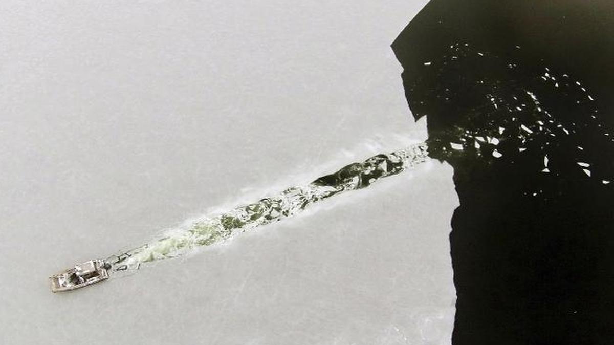 
Assistant harbormaster Isaac Perry uses a boat to break through a fresh layer of ice covering Marion Harbor, Thursday, Feb. 12, 2015, in Marion, Mass. 
