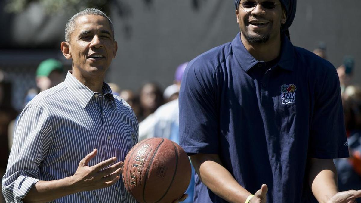 President Barack Obama and former NBA basketball player Etan Thomas play basketball during the 2014 White House Easter Egg Roll at the White House in Washington. When Thomas suspected a woman declined his request for the open train seat beside her because of race, he confronted her and posted her photo to Facebook with the story.