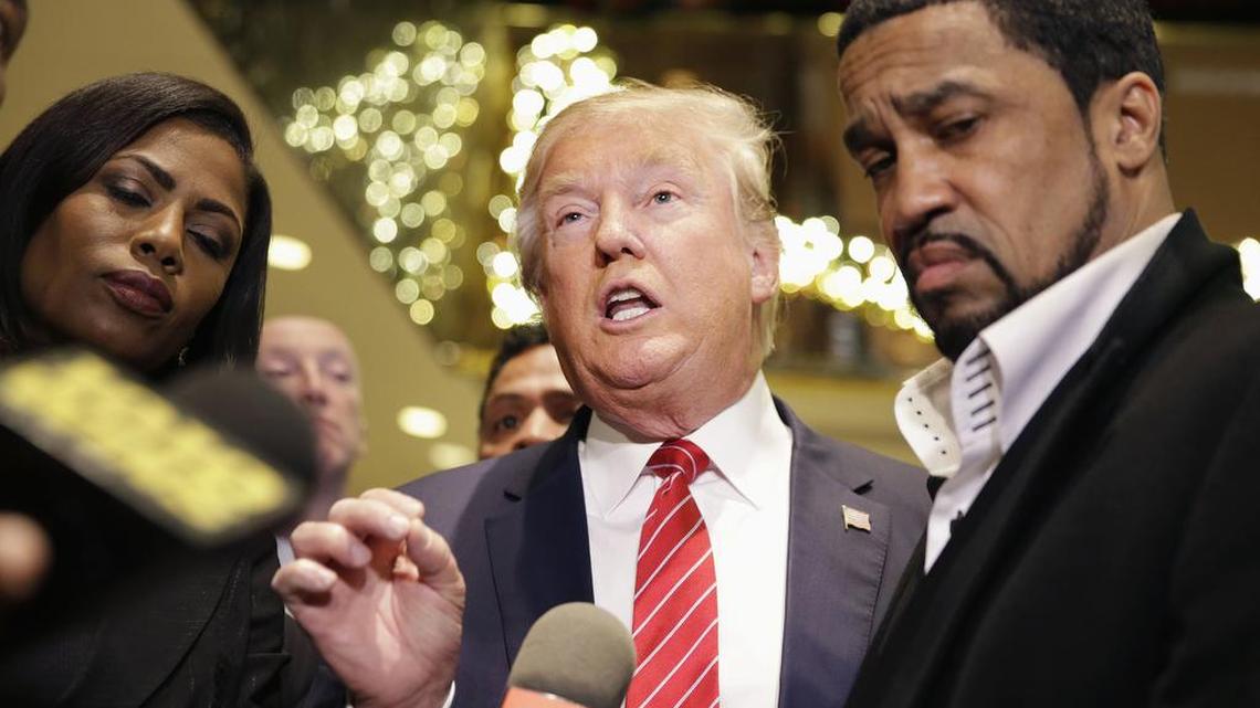 Republican Presidential candidate Donald Trump, center, talks with reporters while surrounded by a group of African-American religious leaders in New York on Monday following a meeting with a coalition of 100 African-American evangelical pastors and religious leaders in a private meeting at Trump Tower.