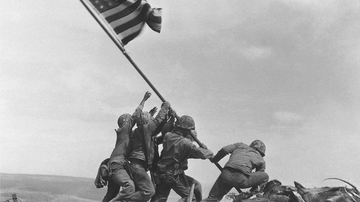 In this Feb 23, 1945 photo, U.S. Marines of the 28th Regiment, 5th Division, raise the American flag atop Mt. Suribachi, Iwo Jima, Japan. The Marine Corps said Monday that it has begun investigating whether it mistakenly identified one of the men shown after two amateur history buffs began raising questions about the picture.