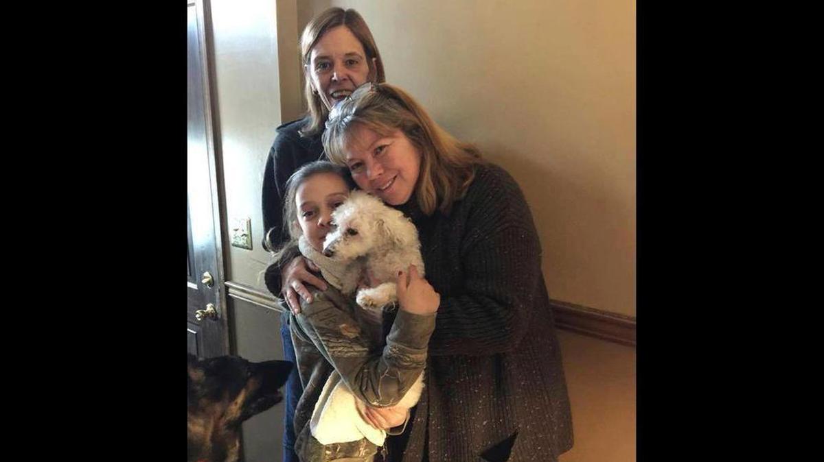 In this photo provided by Jessica Hartman, Monica Newhard, right, and her granddaughter, Helen Welch, hold their dog, Zoey, as Zoey’s rescuer, Christina Hartman, stands behind them, Wednesday, Jan. 3, 2018, in Palmerton, Pa.