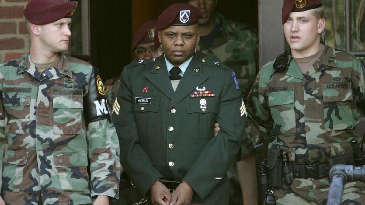 Sgt. Hasan Akbar, center, is led from the Staff Judge Advocate Building at Fort Bragg, N.C., on Monday, April 25, 2005, during the sentencing phase of his court-martial.