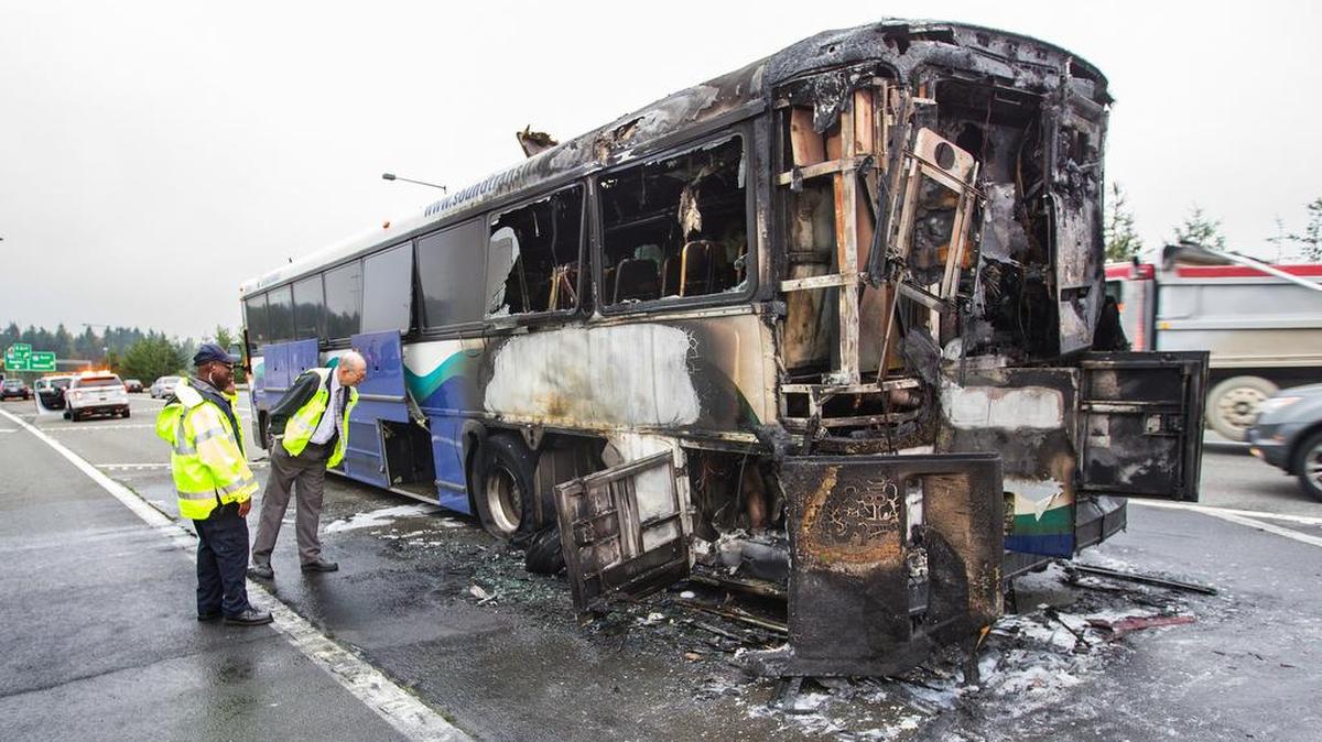 
Officials look over the charred remains of a Sound Transit bus on the shoulder of northbound Interstate 405, Wednesday, Oct. 14, 2015 near Interstate 90 near Bellvue, Wash. 
