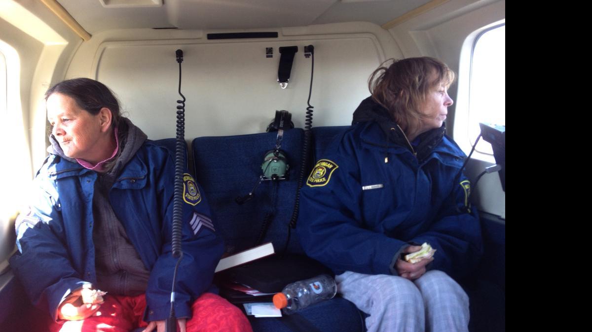 
Sisters Leslie Roy, right, and Lee Marie Wright sit in a Michigan State Police helicopter after they were rescued Friday, April 24, 2015 from Michigan's Upper Penisula. 
