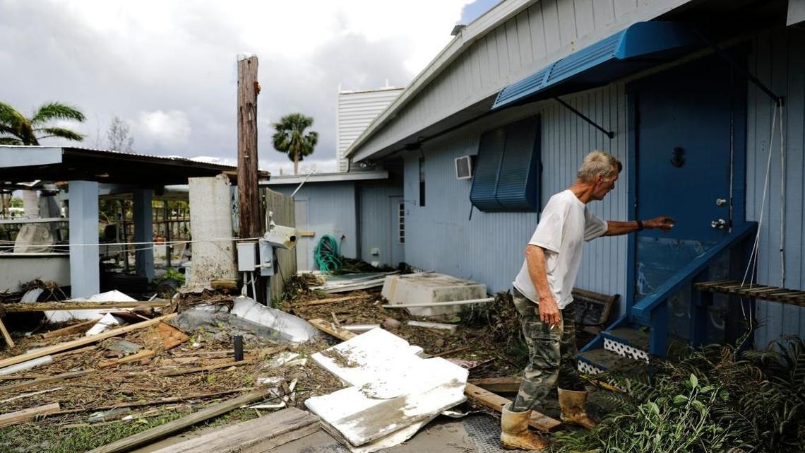 Kenny Crippen, walks past debris into his home where he rode out Hurricane Irma on Plantation Island, Fla., Monday, Sept. 11, 2017. "I've never run from any storm," said Crippen who has lived in the Everglades for 30 years. "I'm rooted here. I'm not leaving."