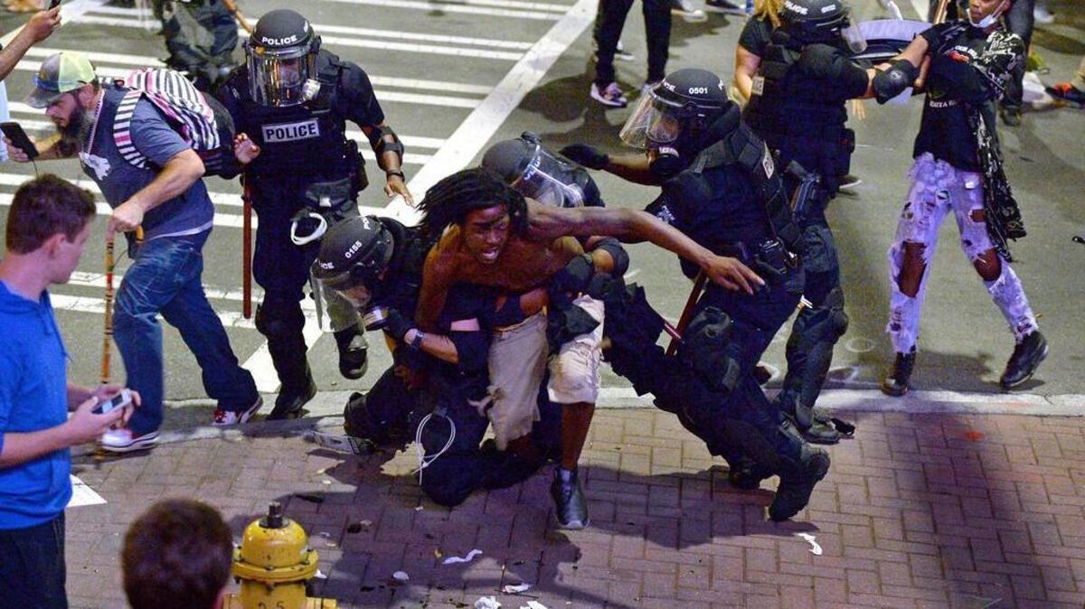 Officers take a protestor into custody in Charlotte, N.C., on Wednesday, Sept. 21, 2016. The protestors were rallying against the fatal shooting of Keith Lamont Scott by police on Tuesday evening in the University City area.