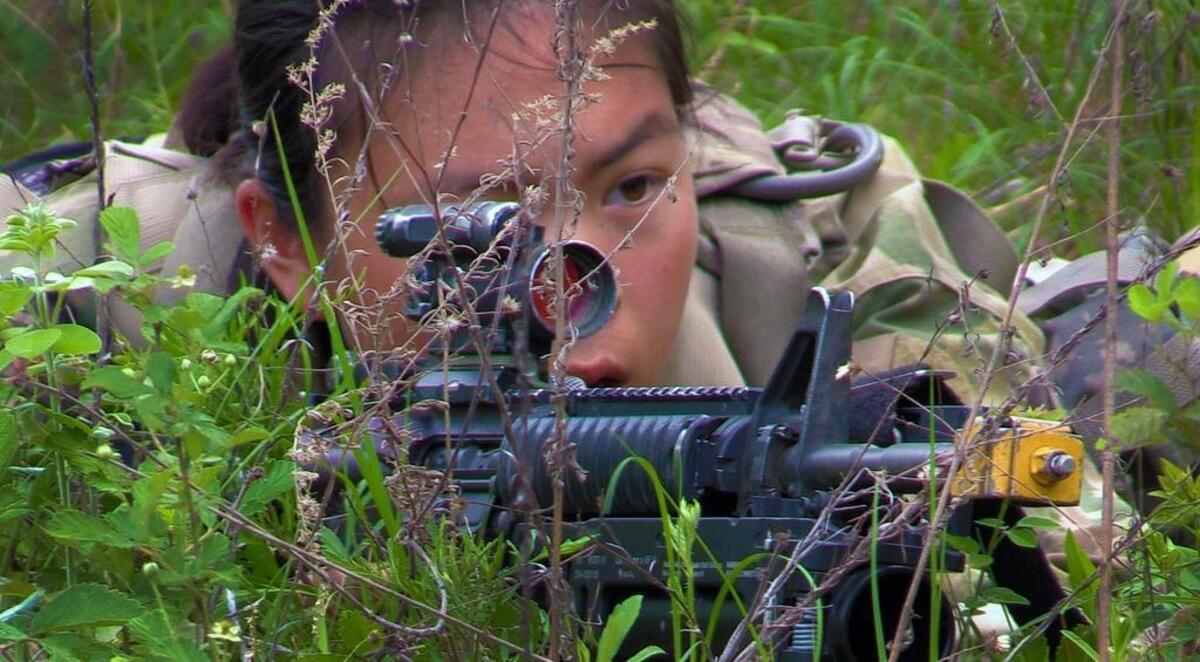 A female soldier in Alpha Company, 1st Battalion, 19th Infantry Regiment seeks cover during the final field training exercise of One Station Unit Training at Fort Benning, Georgia.The third and final phase of U.S. Army gender integration reached a significant milestone Friday when 18 women graduated from active duty basic training at Fort Benning, becoming infantrymen.
