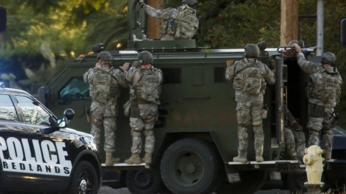 SWAT team members depart the location where two suspects with assault rifles were killed in a shootout following the mass shooting of 14 people at the Inland Regional Center in San Bernardino, Calif., on Wednesday, Dec. 2, 2015.