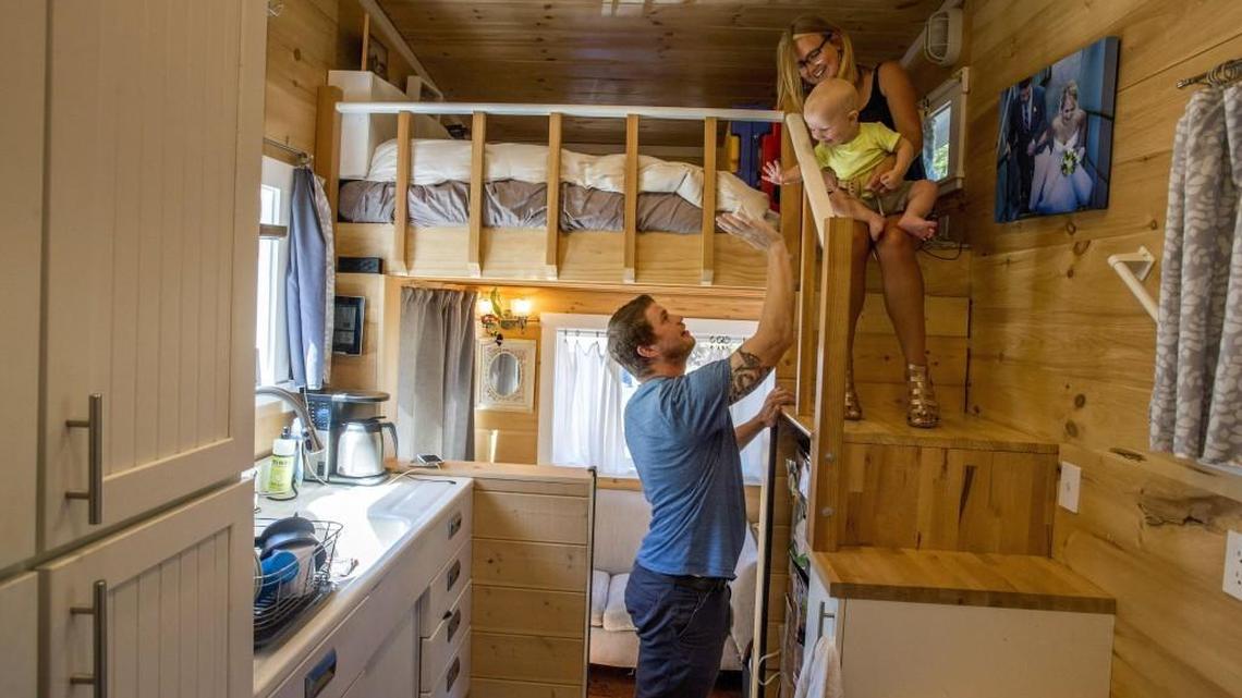 Peter and Shannon Johnson and their toddler Hart at a tiny house of their own construction Aug. 11. They built it on a trailer and have installed it on their property in Steilacoom. The town sent a letter to the couple Tuesday telling them the home violates town code and they have 30 days to move out.