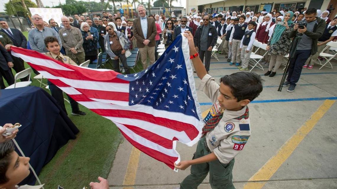 Isa Siddiqi helps raise a U.S. flag at Orange Crescent School before a press conference about a threatening letter the school received in Garden Grove, California. The school, which is part of the Islamic Society of Orange County, received threats along with many other Southern California mosques around Thanksgiving saying President-elect Donald Trump will "cleanse" the U.S. of Muslims.