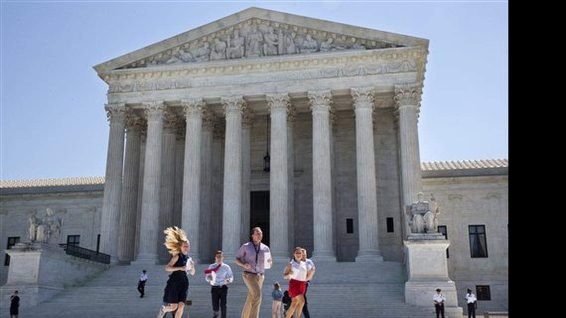 New interns run with a decision across the plaza of the Supreme Court in Washington, Monday June 29, 2015. On Monday, the court upheld Arizona congressional districts drawn by an independent commission and rejected a constitutional challenge from Republican lawmakers and upheld the use of a controversial drug in lethal injection executions Monday, as two dissenting justices said for the first time that they think it's "highly likely" that the death penalty itself is unconstitutional.