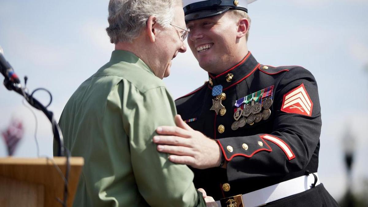 Dakota Meyer, right, shakes hands with Sen. Mitch McConnell of Kentucky at the Cow Days parade in Greensburg, Ky., Sept. 17, 2011.
