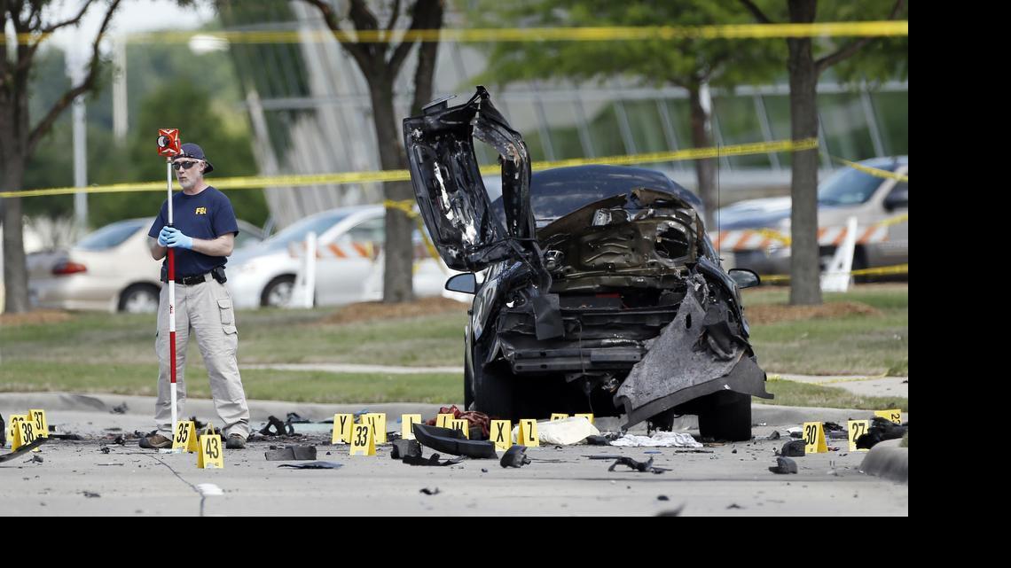 
FBI crime scene investigators document evidence outside the Curtis Culwell Center, Monday, May 4, 2015, in Garland, Texas. Two men opened fire with assault weapons on police Sunday night who were guarding a contest for Muslim Prophet Muhammed cartoons. A police officer returned fire killing both men. 
