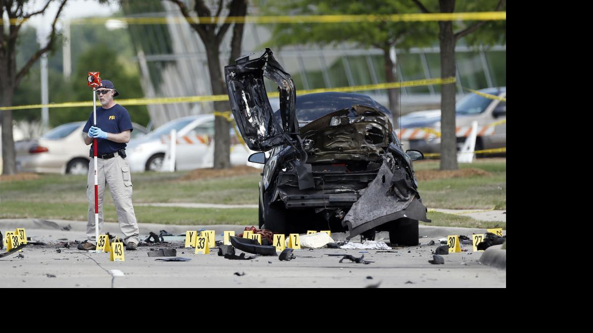 
FBI crime scene investigators document evidence outside the Curtis Culwell Center, Monday, May 4, 2015, in Garland, Texas. Two men opened fire with assault weapons on police Sunday night who were guarding a contest for Muslim Prophet Muhammed cartoons. A police officer returned fire killing both men. 
