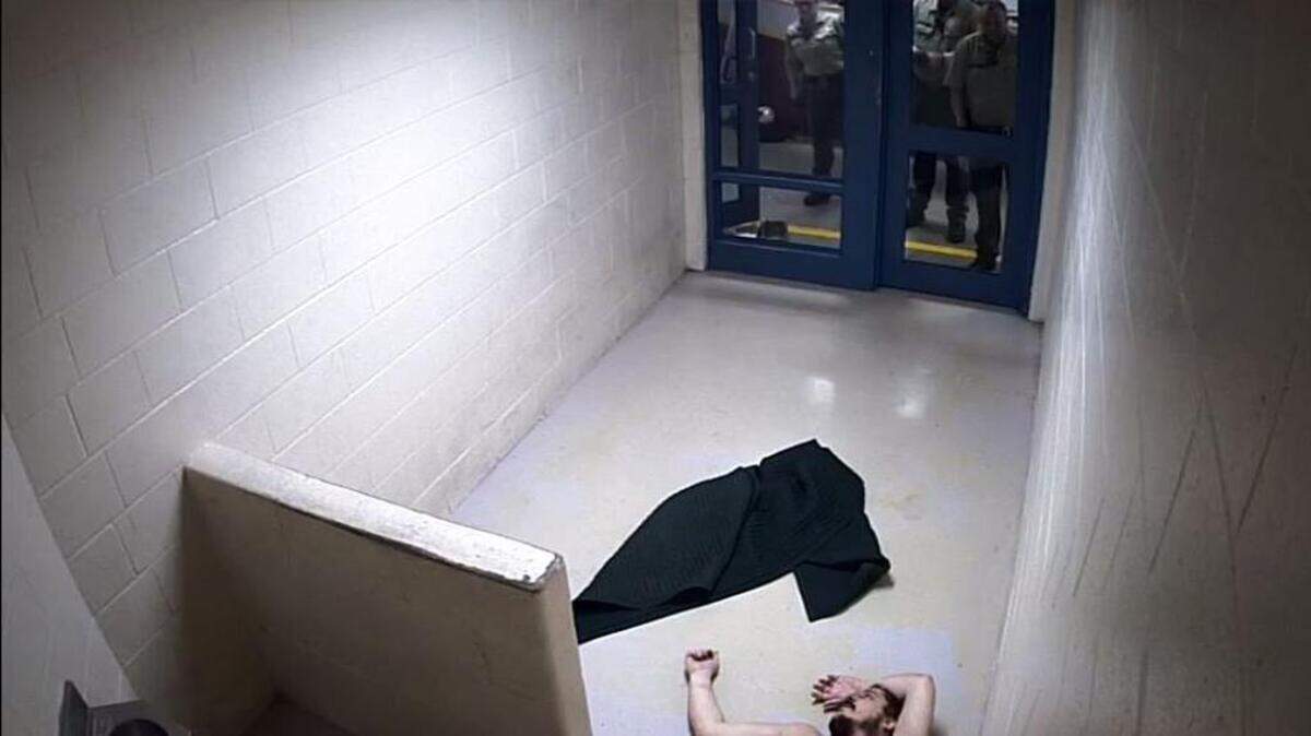 Atascadero resident Andrew Holland, 36, at the moment he appears to lose consciousness while Sheriff's deputies look on in the San Luis Obispo County Jail on Jan. 22, 2017.
