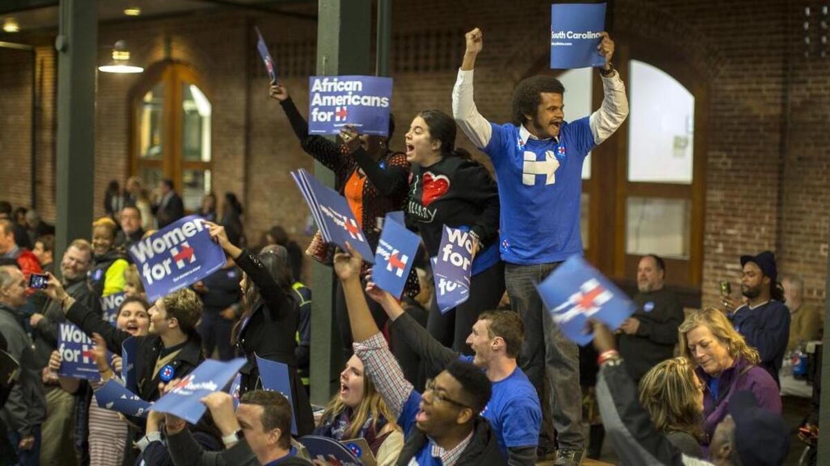 Supporters wave signs and cheer while they wait for Democratic presidential candidate Hillary Rodham Clinton to arrive at the Jim Clyburn Fish Fry, on Jan. 16, 2016, at the Charleston Visitor Center in Charleston, S.C.