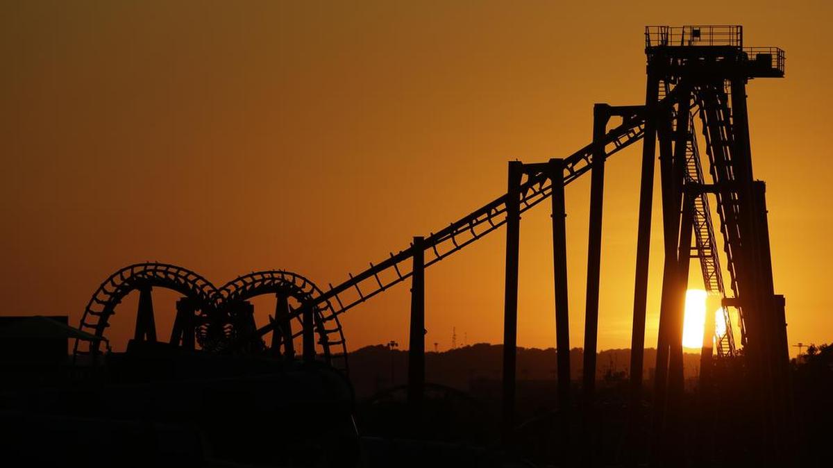 The sun sets behind a roller coaster at Kentucky Kingdom amusement park in Louisville, Kentucky on June 9.