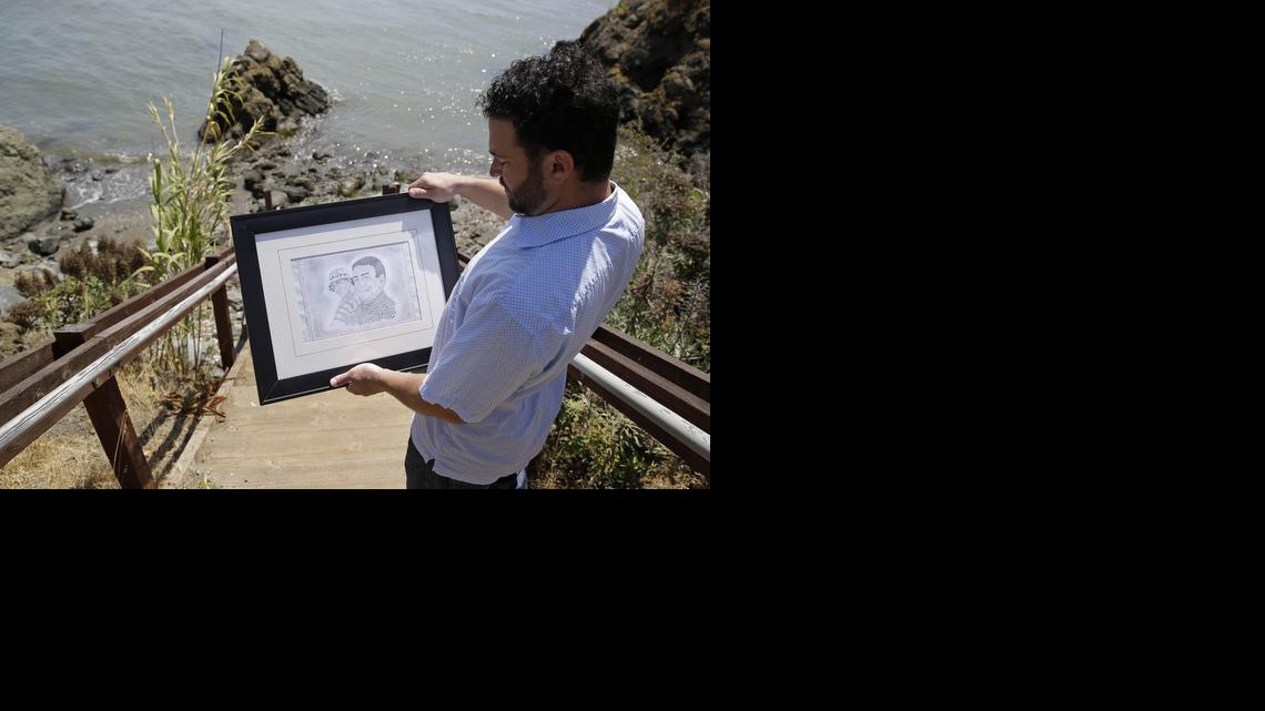 
Dan Ager looks at a graphite sketch of his father, Alan Ager, and him, while walking toward a beach outside San Quentin State Prison in San Quentin, Calif. Alan Ager was killed in 2010 at Salinas Valley State Prison and also served time in San Quentin. California state prison inmates are killed at a rate that is double the national average, and sex offenders such as Alan Ager account for a disproportionate number of victims, according to an Associated Press analysis of corrections records. 
